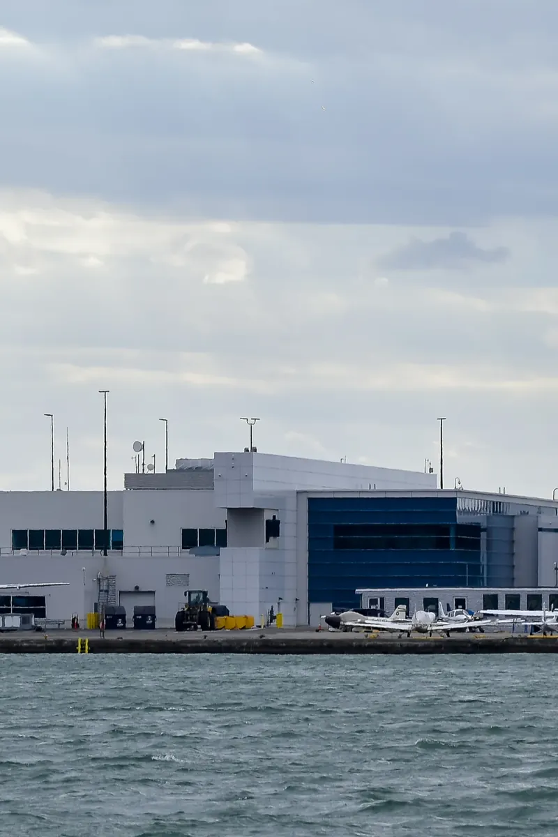 Billy Bishop Toronto City Airport terminal on the waterfront with small aircraft parked outside